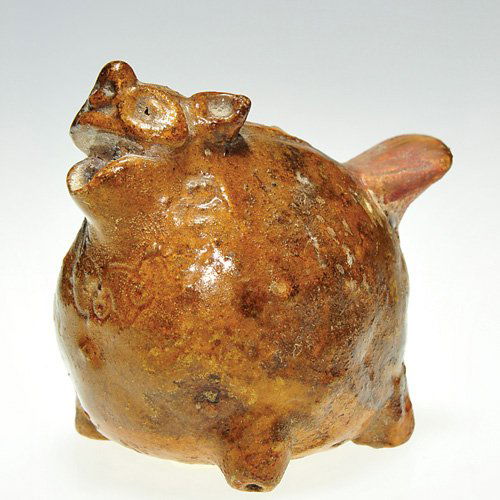 Ceramic water dropper, badger, glazed,2 1/2"X2 3/4: Ceramic water dropper shaped as a plump and happy badger, a necklace scratched in about his neck. The critter is crudely covered with a semi gloss caramel brown glaze. He is tall as he is wide at 2 1/