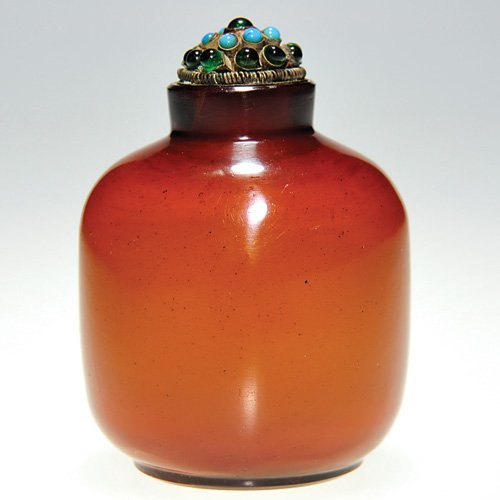 Snuff bottle,carnelian,stopper turquoise-green bea: Nice carnelian snuff bottle topped with a metal cap mounted with eight turquoise and twelve emerald green beads. Height 3 1/2 inches. Minor half inch surface scratch. Attractive bottle.