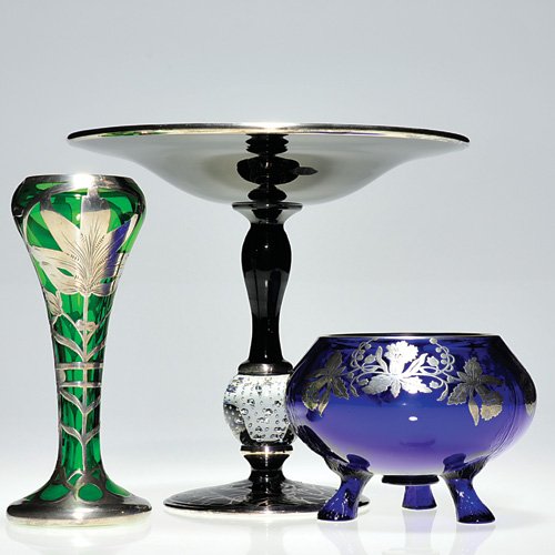Three silver overlay:1 Pairpoint attrib: Three silver overlay articles: 1) Nice black glass tazza, attributed to Pairpoint having a controlled bubble sphere. The tray overlaid with flowering stems joining three circles each containing a gaze