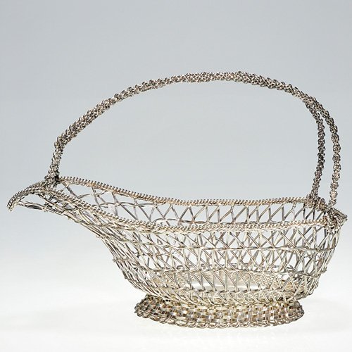 Mexican silver bottle basket, 8", Villasana 925: Mexican silver basket for a spirit bottle with an open platted body lofted on a basket weave base and having generous double rope twist handles. Height 8 inches, length 10 3/4 inches. Impressed "Taxco