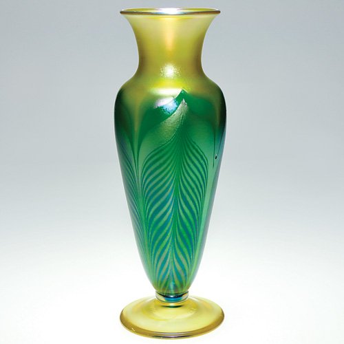 Orient & Flume vase, feathers, Smallhouse, 12": Tall Orient & Flume vase by master artisan David Smallhouse placing green feathers pulled over a golden iridescent surface. Height 12 inches. The transparent yellow foot bears the name of the artist a