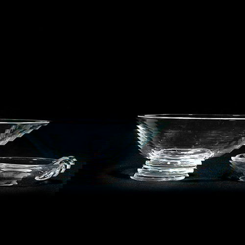 2 Steuben: Fruit bowl, 4 1/2"X12 1/4"D; ash tray,: Two articles of Steuben crystal: (1)Large fruit bowl fastened onto a triple ridged disc, 4 1/2 inches by 12 1/4 inches in diameter. (2)Ash receiver, shape 8008, 1 5/8 inches by 6 1/4 inches in diamete