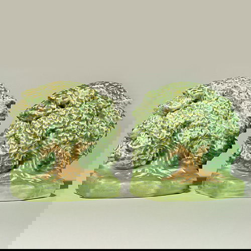 Rookwood dichrome Oak Tree bookends; 1928, 5 5/8": Scarce Oak Tree bookends, 5 5/8 inches by 6 inches, showing an oak tree in brown with green leaves tinged with brown growing from a verdant ground. Marked with the Rookwood logo, the 1928 date and sha