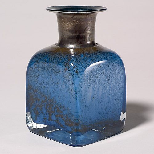 Vallien, Bertil bottle vase, square, blue, metalli: Squared bottle vase showered with tawny pigments drifting over a medium blue ground, the throat covered with a matte metallic glaze, bottom engraved "B (Bertil) Vallien, Boda-Afors." Height 7 inches.