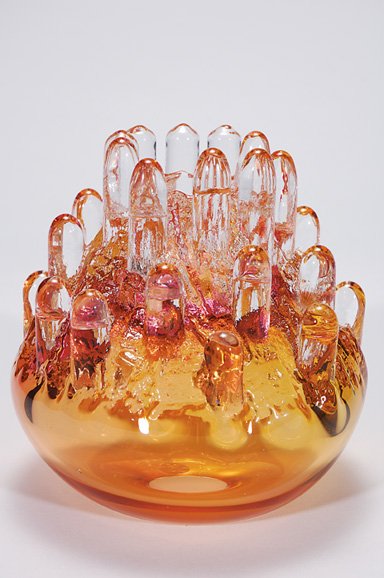 Kosta sculpture vase, G. Warff, 7 1/2", amber: Unique glass sculpture designed by Goran Warff for Kosta Unik. The sculpture a golden amber with icicle-like formations in crystal resembling a natural stalagmite from limestone caves. A blush of rasp