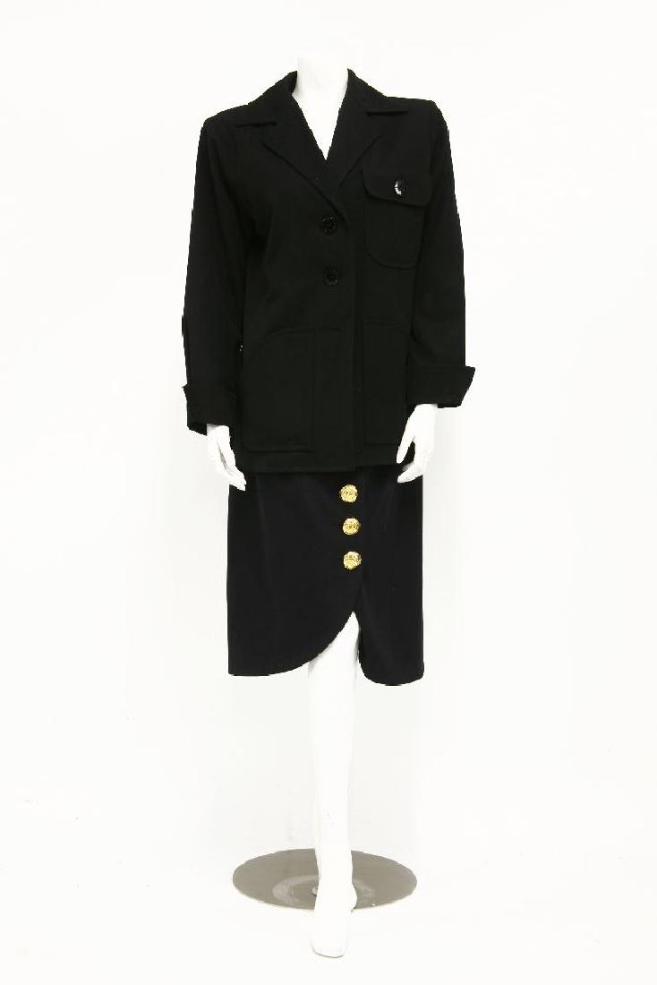 An Yves Saint Laurent black cotton gaberdine jacket: An Yves Saint Laurent black cotton gaberdine jacket,single-breasted with black monogrammed button and safari-style pockets, size 40,an Yves Saint Laurent navy skirt,with gilt buttons to front, size 40