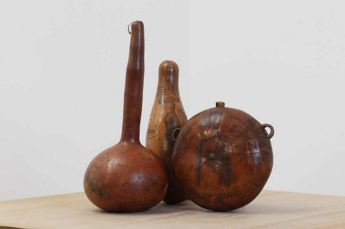 A group of three scrimshawed gourds,: A group of three scrimshawed gourds, A group of three scrimshawed gourds, 19th century, Ajaccio, Corsica and Greece, two powder flasks, one depicting Napoleon, the other a peasant girl, the third with