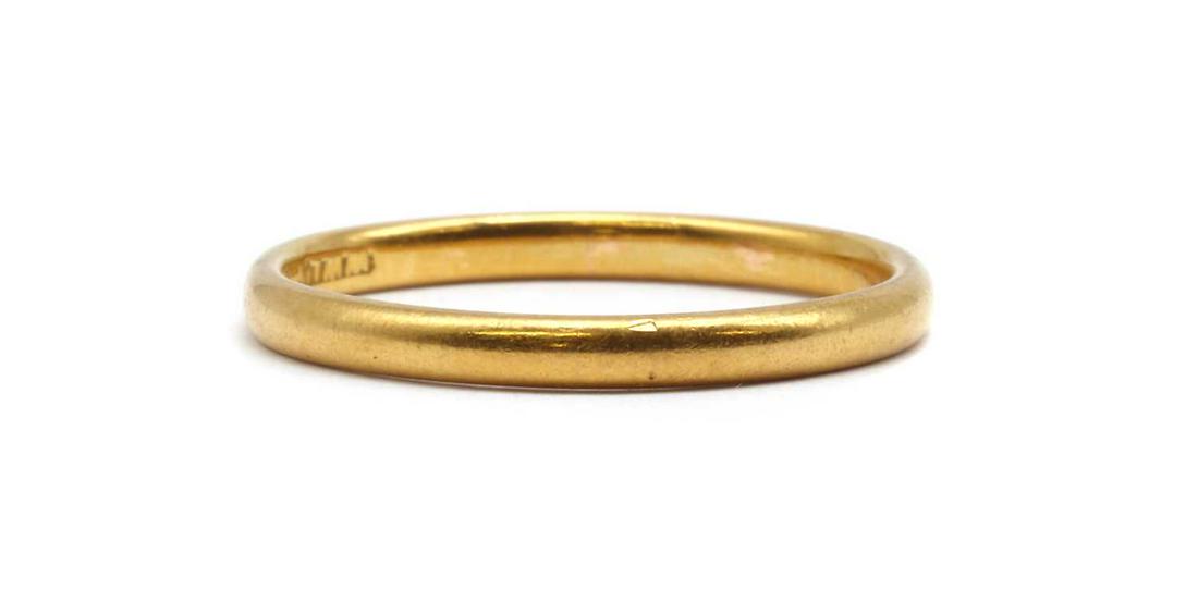 A 22ct gold wedding ring,: A 22ct gold wedding ring, A 22ct gold wedding ring, London 1933, 2.66g. Finger size P Condition report: Surface marks/scratches. Ring out of shape.