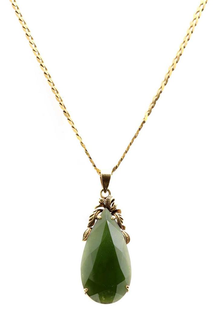 A gold nephrite jade pendant,: A gold nephrite jade pendant, A gold nephrite jade pendant, the faceted pear shaped nephrite jade, claw set, to scroll surmount and articulated bale, suspended on a filed curb link chain with bolt rin