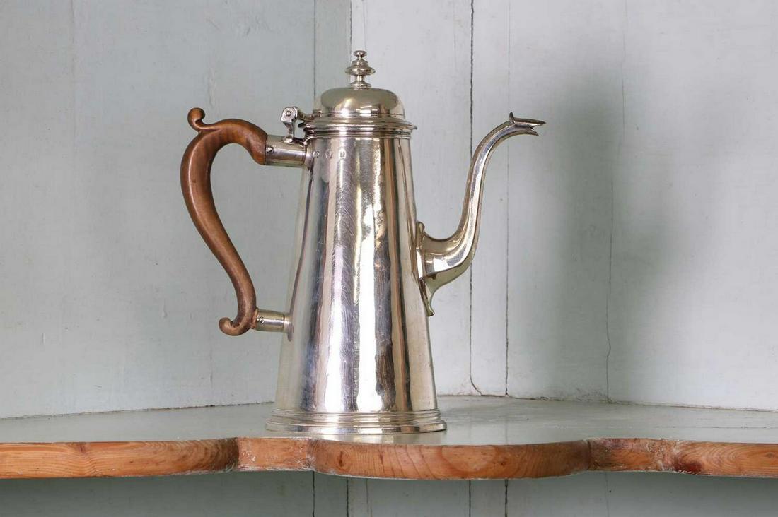 A George I silver coffee pot,: A George I silver coffee pot, A George I silver coffee pot, by George Wickes, London 1726, 21.5cm high, 20.6ozt overall Provenance: The residual contents of Bixley Manor by instruction of the executor