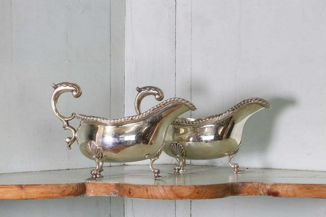 A pair of Edwardian silver sauce or gravy boats,: A pair of Edwardian silver sauce or gravy boats, A pair of Edwardian silver sauce or gravy boats, by Charles Stuart Harris, London 1902, 20cm long, 13cm high, 23.9ozt (2) Provenance: The residual cont