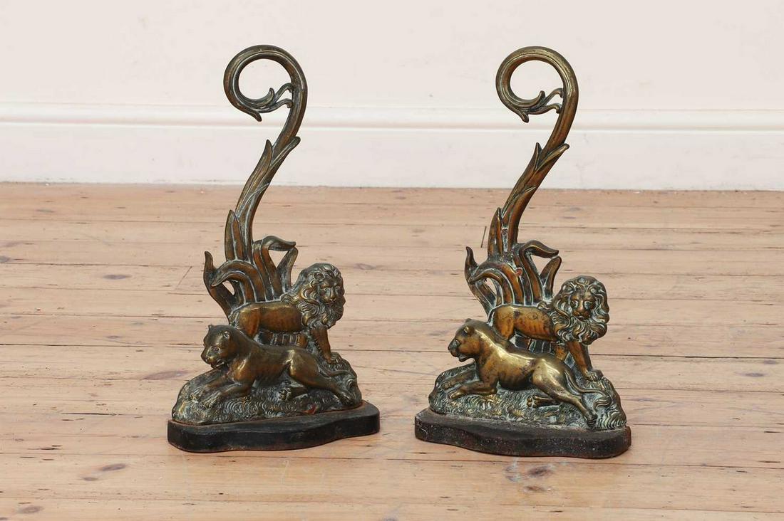 A pair of cast brass doorstops,: A pair of cast brass doorstops, A pair of cast brass doorstops, 19th century, in the form of a lion and lioness, with naturalistic detailed scrolling backs and cast iron weighted bases, 22.5cm wide 41