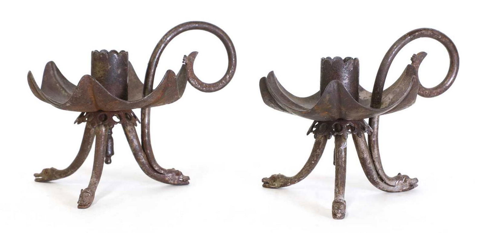 A pair of unusual iron chambersticks, (1 of 3)