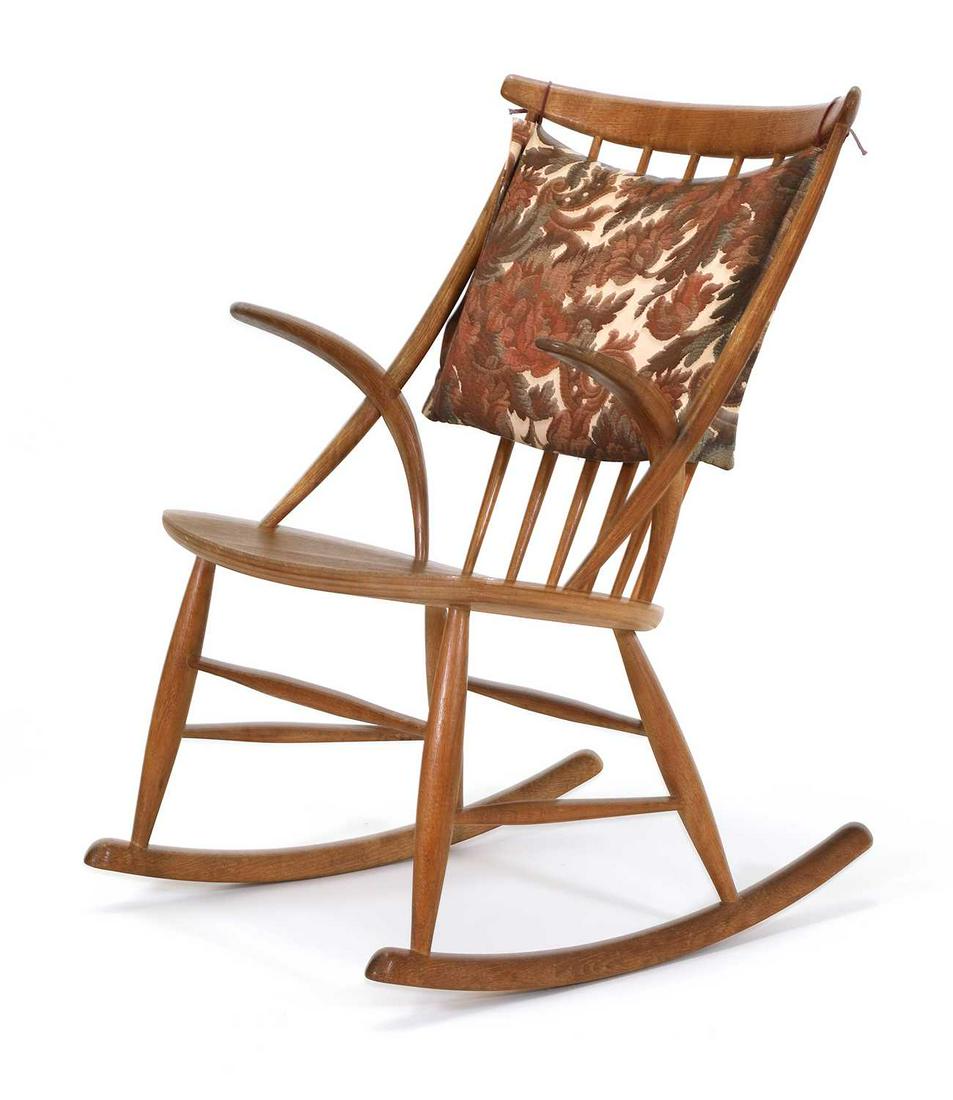 A Danish oak 'Gyngestol No. 3' rocking chair,: A Danish oak 'Gyngestol No. 3' rocking chair, designed by Illum Wikkelsø for Niels Eilersen, with original printed fabric cushion and slung back, traces of an old label to the underneath, 58cm wi