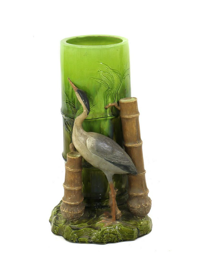 A majolica pottery stick stand,: A majolica pottery stick stand, A majolica pottery stick stand, probably by Bretby, late 19th century, in the form of a heron amongst bamboo, 30cm diameter 60cm high Condition Report: Bottom broken ou