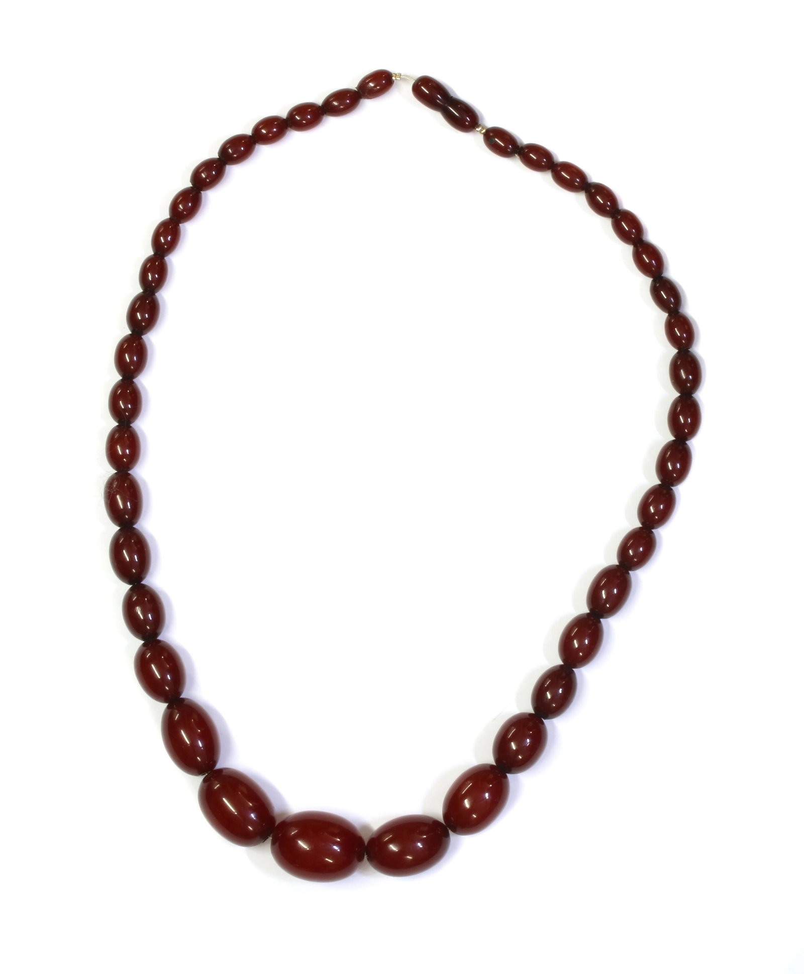 A single row graduated Bakelite bead necklace,: A single row graduated Bakelite bead necklace, A single row graduated Bakelite bead necklace, the beads approximately 25 x 19mm to 11 x 7mm, strung plain on wire, to Bakelite bead clasp, no swirls to