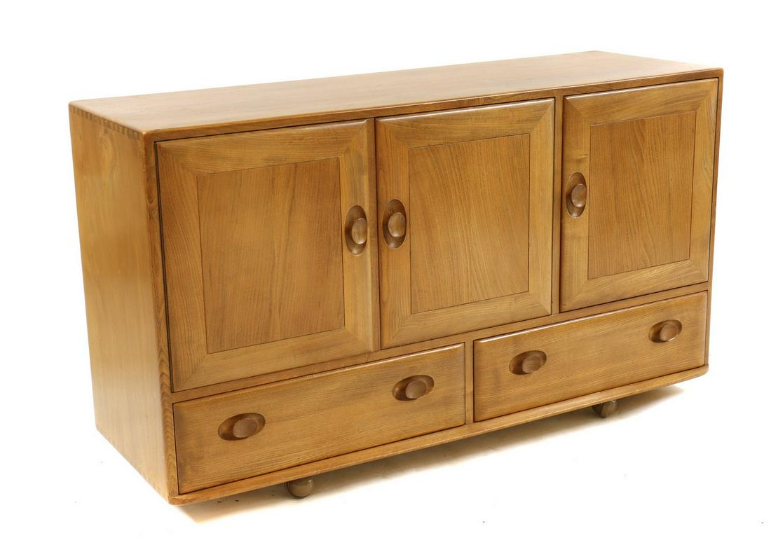 An Ercol model 468 elm sideboard,: An Ercol model 468 elm sideboard, An Ercol model 468 elm sideboard, with an arrangement of three cupboards over two drawers, 130cm wide 44cm deep 76cm high Condition Report: Minor knocks, wear and scu
