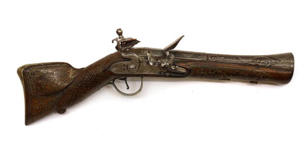 A Turkish flintlock short Blunderbuss: A Turkish flintlock short Blunderbuss A Turkish flintlock short Blunderbuss, early 19th century, signed lock, with 9in two stage twist barrel and wide flared muzzel encrusted with silver scrolling fol