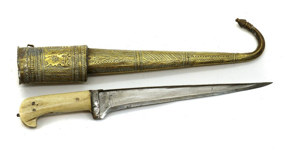 An Afghan Choora Dagger: An Afghan Choora Dagger An Afghan Choora Dagger, 19th century, 10.5in blade engraved decoration, bone hilt, in an engraved brass scabbard terminating in a scroll end 40cm overall Condition Report: Som