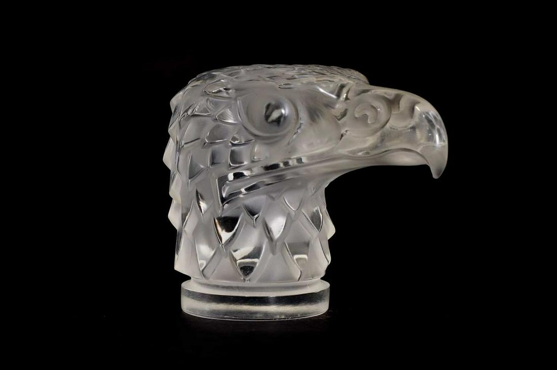 A Lalique 'Tete d'Aigle' clear glass car mascot,: A Lalique 'Tete d'Aigle' clear glass car mascot, A Lalique 'Tete d'Aigle' clear glass car mascot, designed in 1928, modern, with frosted details, engraved 'Lalique R France', 11cm high Condition Repor