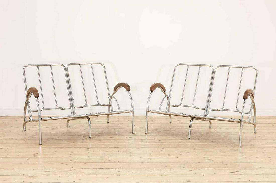 A pair of 'du-al' chrome settees,: A pair of 'du-al' chrome settees, A pair of 'du-al' chrome settees, each with wood mounted arms and original vinyl cushions, worn, labelled 'A Dare-Inglis Product du-al', frames 114cm wide 85cm deep 7