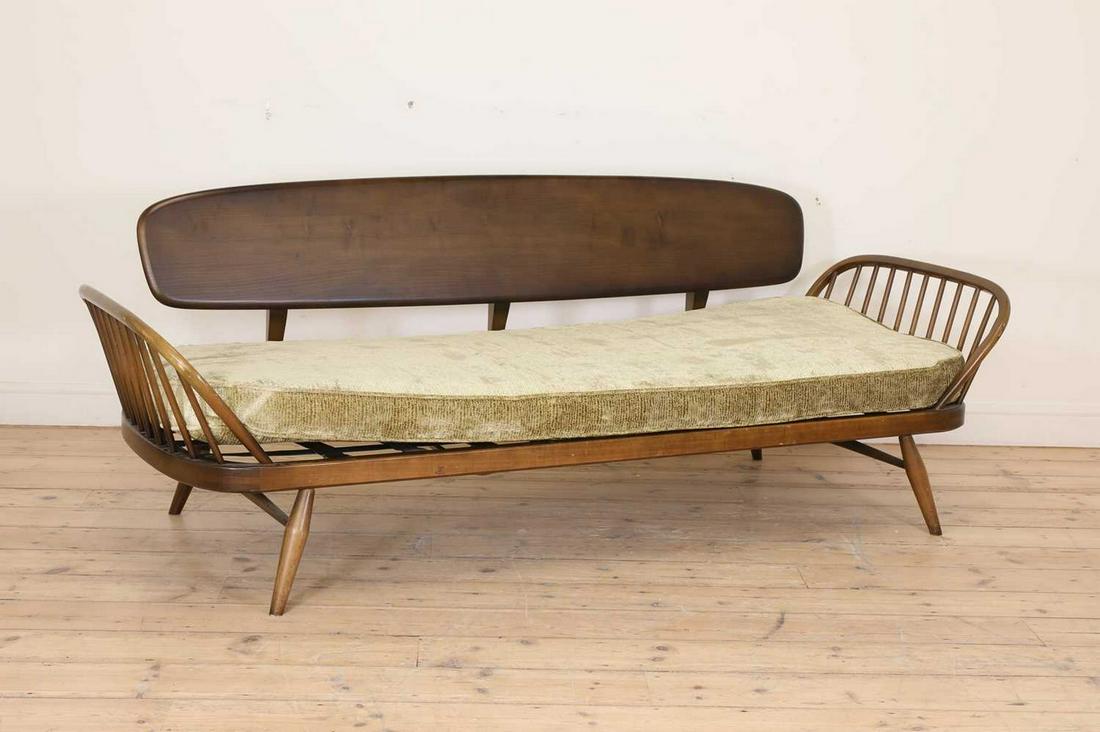 An Ercol 'Model 355 Studio' daybed,: An Ercol 'Model 355 Studio' daybed, An Ercol 'Model 355 Studio' daybed, designed in 1956 by Lucian Ercolani for Ercol, the stained beech and elm frame with a single squab cushion upholstered in Edinbu