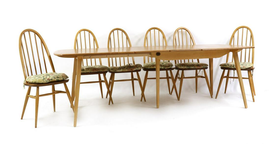 An Ercol dining suite: An Ercol dining suite An Ercol dining suite, comprising a set of six elm and beech Quaker chairs, each with a hooped spindle back, 51cm wide 52cm deep 97cm high, seat 42cm high and an extending Windso