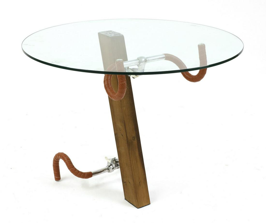 A contemporary bicycle coffee table,: A contemporary bicycle coffee table, A contemporary bicycle coffee table, in the manner of Jasper Morrison, with handlebar supports on a diagonal stem, surmounted by a circular glass top, 87cm diamete
