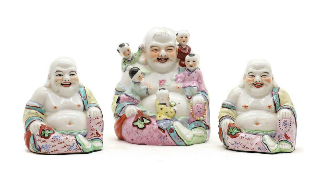 A Chinese famille rose Budai,: A Chinese famille rose Budai, A Chinese famille rose Budai, 20th century, seated wearing a loose robe exposing his round belly holding a rosary in his left hand and a sack bag in his right, with five