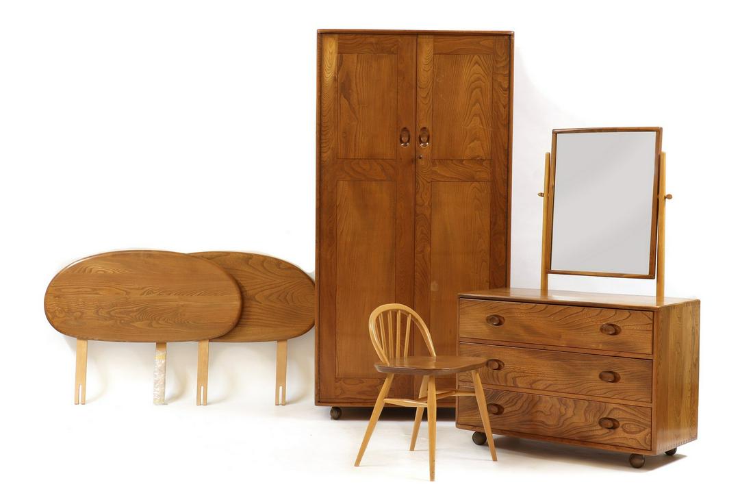 An Ercol elm bedroom suite: An Ercol elm bedroom suite An Ercol elm bedroom suite, mid-20th century, comprising a two door wardrobe, a dressing chest, two single headboards and a dressing chair, wardrobe; 91.5cm wide 54cm deep 1