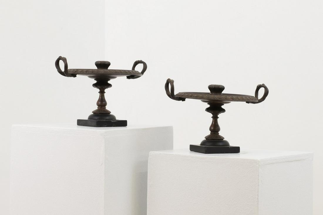 A pair of bronze candlesticks, (1 of 5)