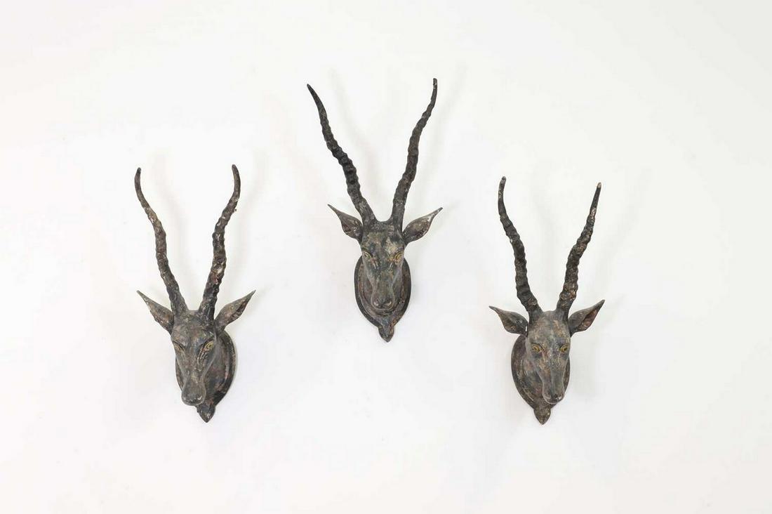 A set of three carved polychrome antelope, (1 of 5)