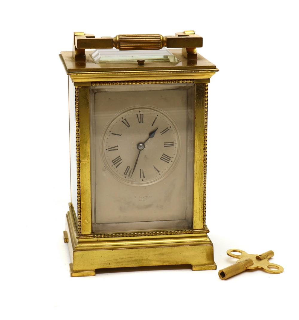 A brass cased carriage clock: A brass cased carriage clock A brass cased carriage clock, c.1900, the silvered dial with Roman numerals, the two train movement striking on a gong with a repeater, stamped for E Maurice & Co, 10cm wi