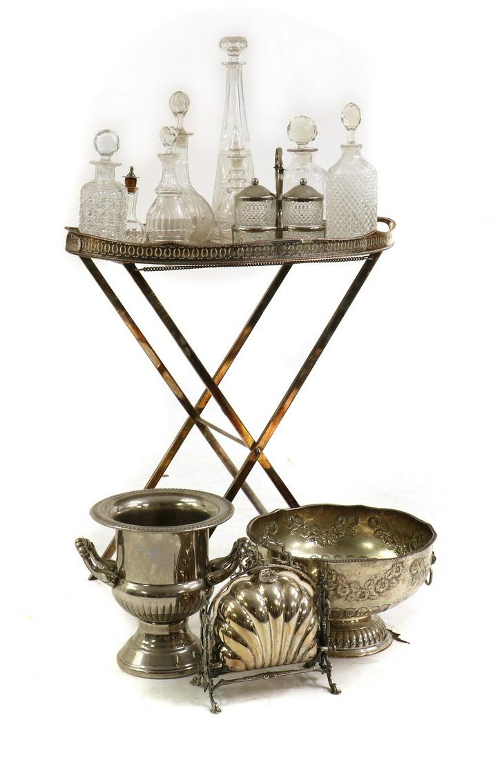 A group of silver plated items: A group of silver plated items A group of silver plated items, comprising a punch bowl, 31cm diameter, a champagne bucket, 26cm high, a two-jar preserve stand, 18cm high, an oval tray on stand, 43cm w