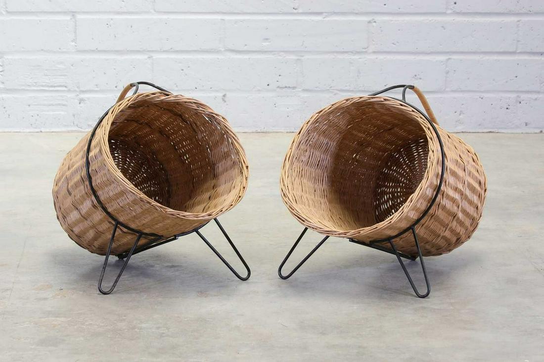 A pair of Swedish wicker log baskets,: A pair of Swedish wicker log baskets, A pair of Swedish wicker log baskets, 1950s, designed by Gunnar Ander for Ystad Metall, each wicker basket on a wrought-iron stand, 33cm diameter 46cm deep 44cm h