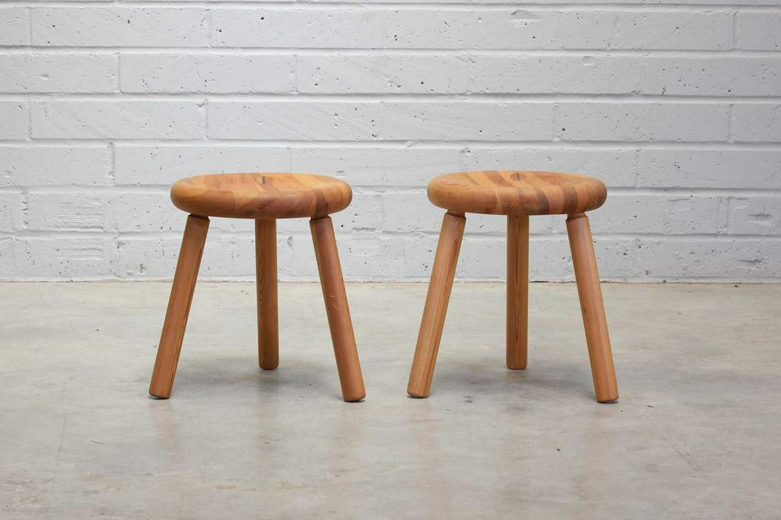 A pair of Finnish pine 'Sauna' stools,: A pair of Finnish pine 'Sauna' stools, A pair of Finnish pine 'Sauna' stools, 1950s, designed by Bertel Gardberg for Villa Jouhki, each dished seat with a hole to the bottom, raised on three turned su