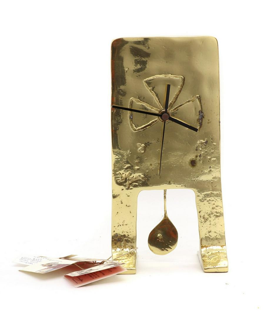 A David Marshall brass mantel timepiece,: A David Marshall brass mantel timepiece, A David Marshall brass mantel timepiece, raised on two integral supports, complete with pendulum, 23.6cm high Condition Report: Minor surface wear and knocks.