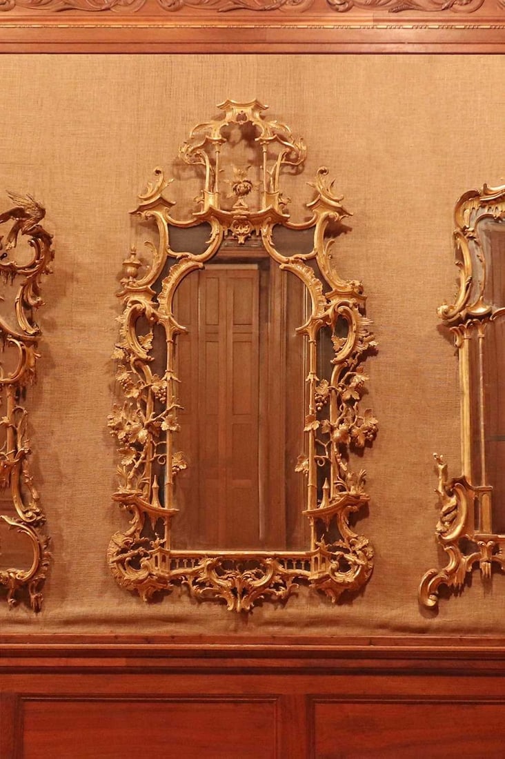 ☘ A George III giltwood mirror,: ☘ A George III giltwood mirror, A George III giltwood mirror, c.1760, Irish, in the manner of Thomas Chippendale, with a later arched plate in shaped mirrored borders, surmounted by a pagoda and