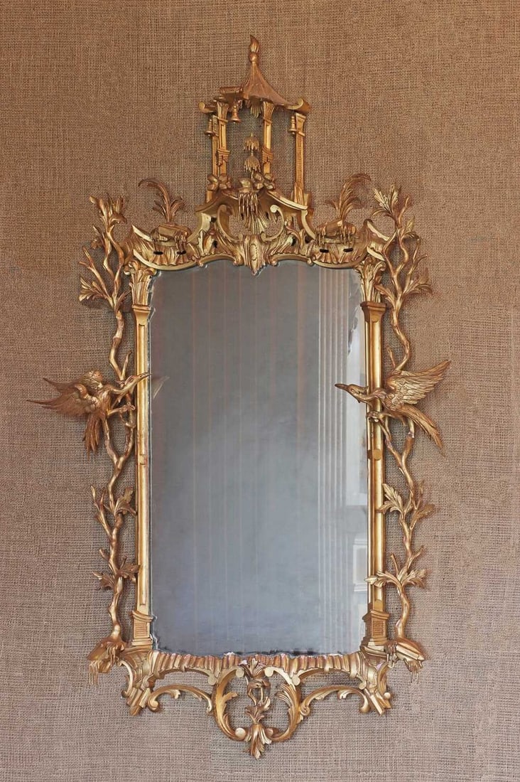 ☘ A giltwood mirror in the manner of Thomas Chippendale,: ☘ A giltwood mirror in the manner of Thomas Chippendale, A giltwood mirror in the manner of Thomas Chippendale, late 19th century, carved with a pagoda top, leafy branches and ho-ho birds, 94cm