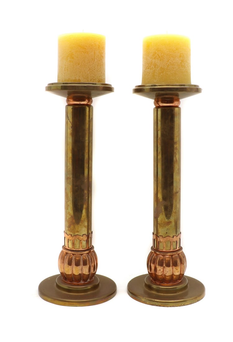 A pair of brass and copper candlesticks (1 of 3)