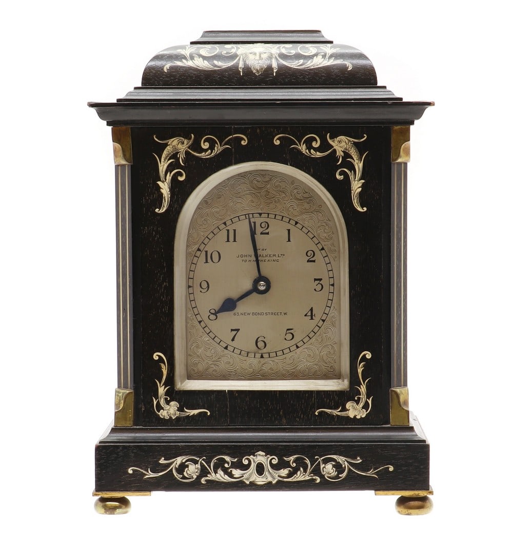 An ebonised and ivory inlaid French style mantel clock,: An ebonised and ivory inlaid French style mantel clock, An ebonised and ivory inlaid French style mantel clock, c.1900, by John Walker Ltd, in the North Italian style, the silvered dial inscribed 'Exd