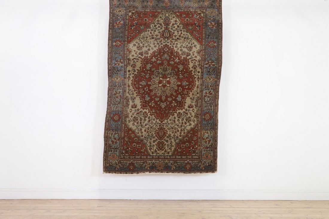 A Persian wool rug, (1 of 4)