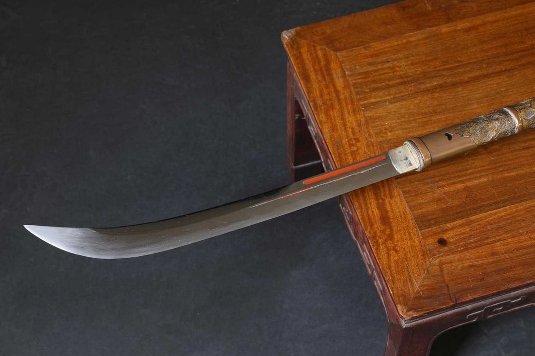 A Japanese naginata,: A Japanese naginata, A Japanese naginata, Edo or Meiji period, the blade with twin fullers, tang signed, the top section of tsuka with mother-of-pearl, and copper mounts, complete with a black lacquer