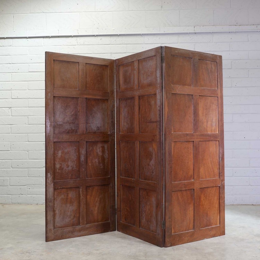 A Cotswold School panelled oak screen, (1 of 2)