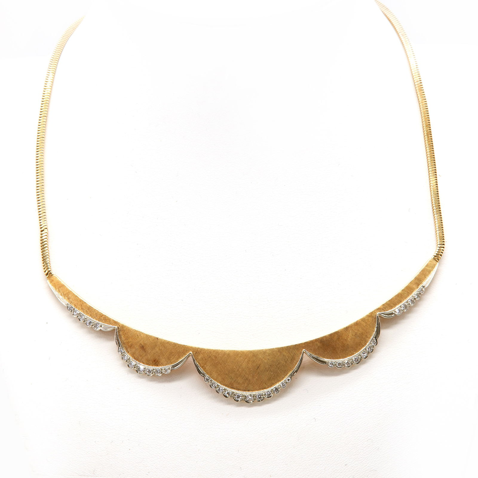 A gold and diamond set swag centrepiece necklace, by Carl Bucherer, c.1960,: A gold and diamond set swag centrepiece necklace, by Carl Bucherer, c.1960, A gold and diamond set swag centrepiece necklace, by Carl Bucherer, c.1960, a graduated curved centrepiece, with a scalloped