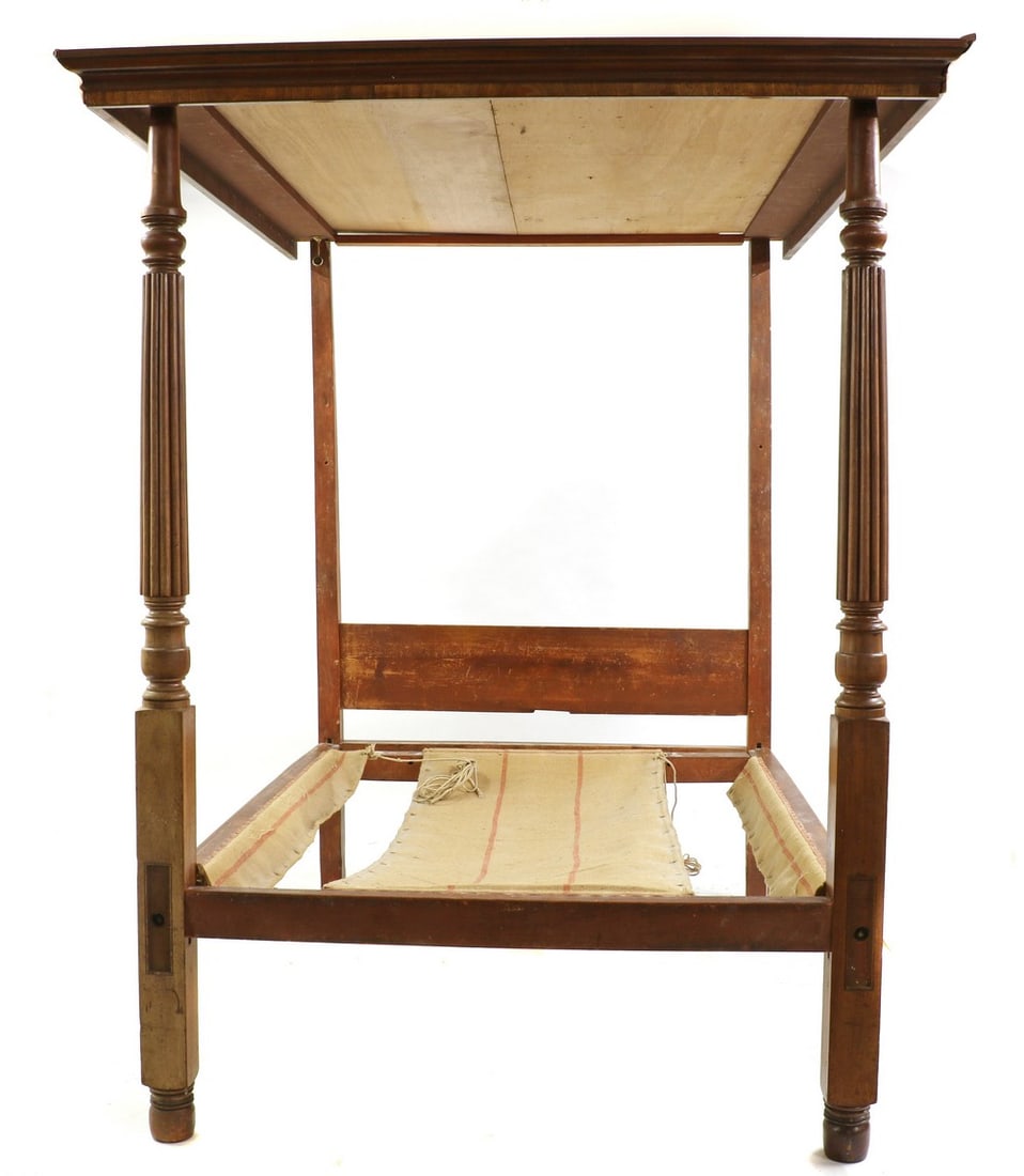 A mahogany four poster bed,: A mahogany four poster bed, A mahogany four poster bed, 19th century, supported by two front reeded columns, 143cm wide 142cm wide 212cm high Condition Report: Knocks and wear throughout. Marks to the