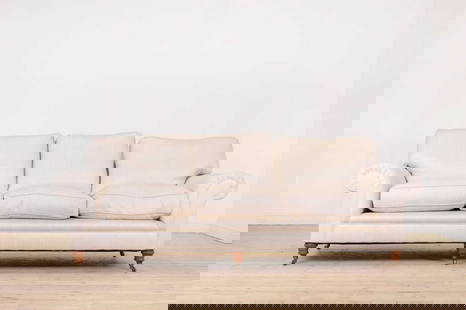A large 'Elverdon' scroll arm sofa by George Smith,: A large 'Elverdon' scroll arm sofa by George Smith, A large 'Elverdon' scroll arm sofa by George Smith, of recent manufacture, raised on turned oak supports, terminating in brass caps and castors, 238