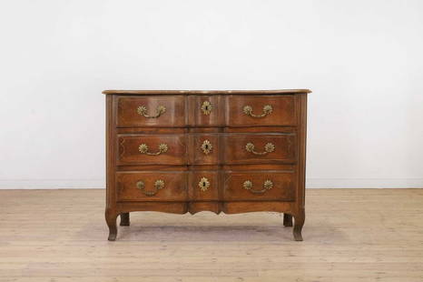 A Louis XV provincial walnut commode,: A Louis XV provincial walnut commode, A Louis XV provincial walnut commode, mid-18th century, French, of serpentine outline with all-over strung decoration and bold brass mounts, raised on square