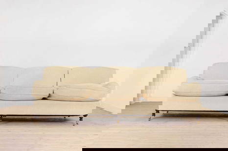 A three-seater sofa by George Smith,: A three-seater sofa by George Smith, A three-seater sofa by George Smith, of recent manufacture, upholstered in yellow fabric and raised on ring-turned supports, terminating in brass caps and castors,