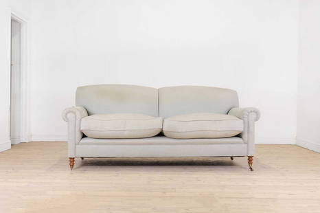 A two-seater sofa by George Smith,: A two-seater sofa by George Smith, A two-seater sofa by George Smith, of recent manufacture, upholstered in blue fabric with scroll arms and ring-turned supports, terminating in brass caps and